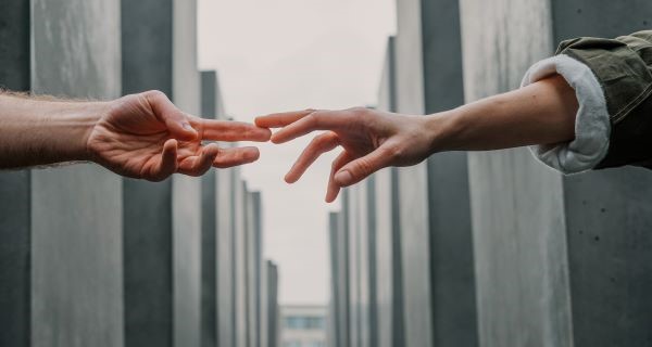 Hands reaching through barriers to touch